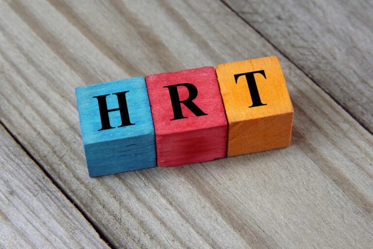 Colorful wooden blocks spelling out "HRT" representing hormone replacement therapy
